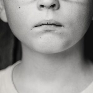 bottom half of a child's face looking sad